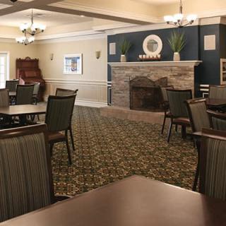 A cozy dining room with a fireplace and elegant furniture.