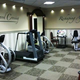 A well-equipped gym with various exercise machines and a welcoming atmosphere.
