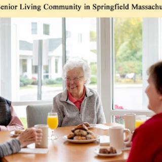 Residents enjoying breakfast and conversation in a senior living community in Springfield, Massachusetts.