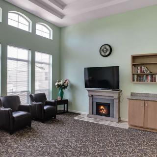 A cozy living room with a fireplace, television, and seating area.