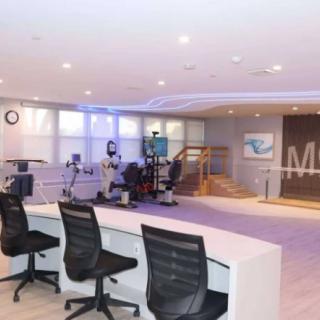 A spacious, modern conference room with desks and chairs.