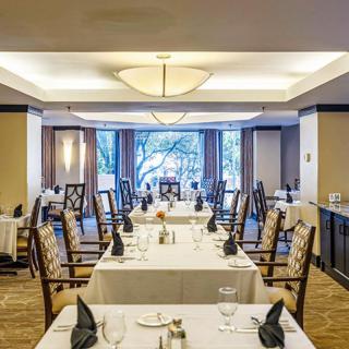 A beautifully set restaurant dining area with elegantly arranged tables and chairs.