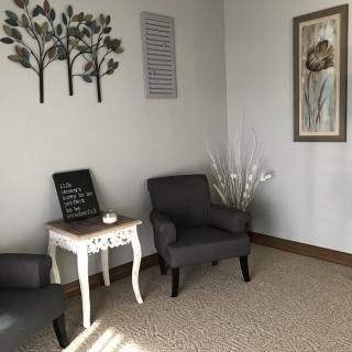 A cozy waiting room with comfortable seating and decorative accents.