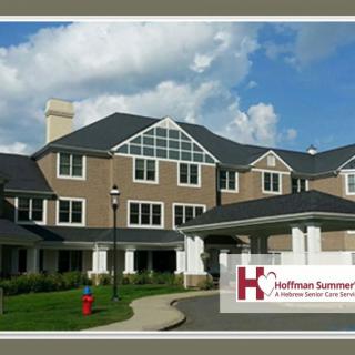 A modern healthcare facility with a welcoming entrance and a backdrop of a partly cloudy sky.