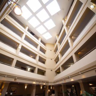 A modern atrium with multiple floors and a large skylight.