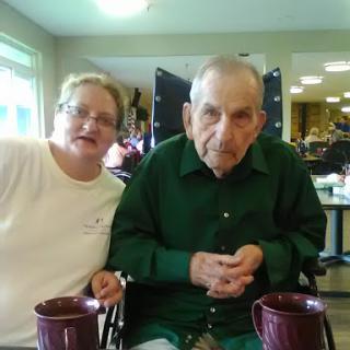 A touching moment between a caregiver and an elderly resident.