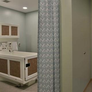 A hospital procedure room with a privacy curtain and medical table.
