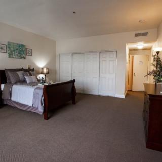 A cozy bedroom with a comfortable bed, dresser, and inviting decor.