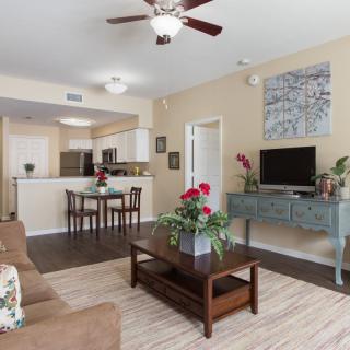A cozy open-plan living space featuring a comfortable seating area, a dining corner, and a modern kitchen.