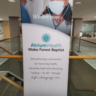 A banner promoting Atrium Health Wake Forest Baptist, emphasizing their commitment to strengthening health and wellness.
