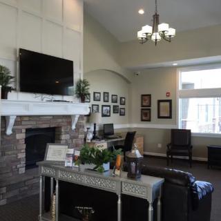 A cozy living room with a fireplace, television, and comfortable seating.
