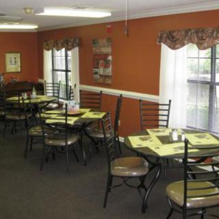 A cozy restaurant dining area with tables and chairs set for guests.