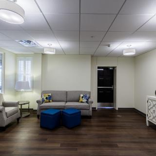A modern lounge area featuring comfortable seating and contemporary lighting.