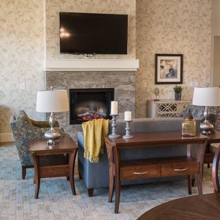 A cozy living room with a fireplace, television, and comfortable seating.