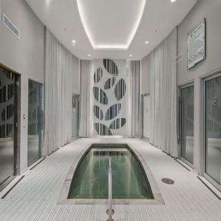 A serene and modern indoor pool area with sleek architectural design.