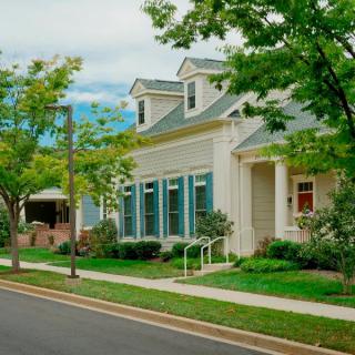 A charming suburban house with a well-maintained lawn and street view.