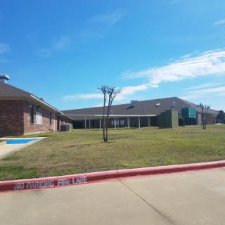 A view of a residential building under a clear blue sky.