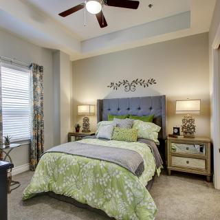 A modern and cozy bedroom with elegant decor, featuring a comfortable bed and ambient lighting.