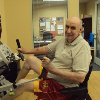 A person exercising on a stationary bike indoors.