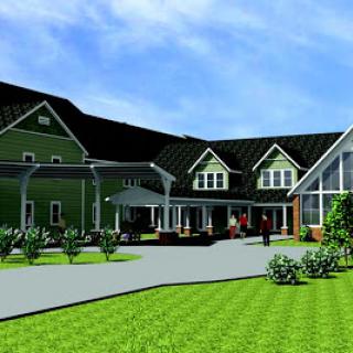 A contemporary residential building featuring a blend of traditional and modern architectural elements, surrounded by lush greenery.