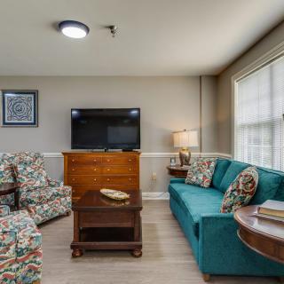 A cozy living room with comfortable seating and a television.
