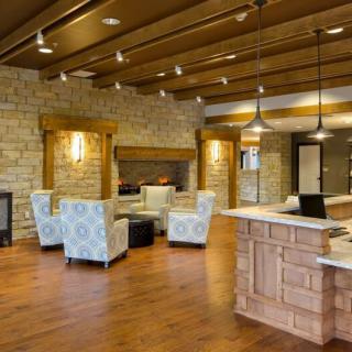 A modern and cozy lobby area with comfortable seating and warm lighting.