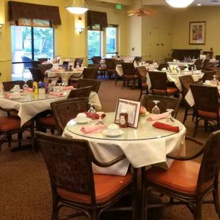 A cozy dining room setup with elegantly arranged tables and chairs.