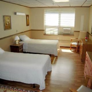 A cozy bedroom with two single beds and natural lighting.