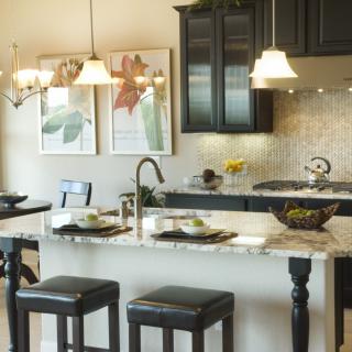 Modern kitchen with stylish countertops, elegant lighting, and comfortable seating.