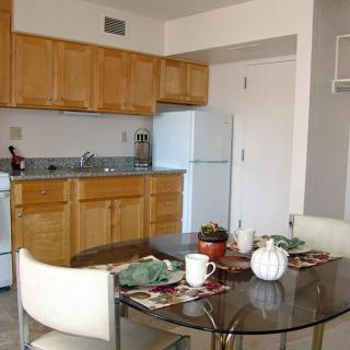 A cozy apartment kitchen with a dining table set for two.