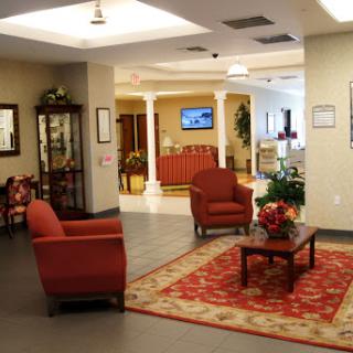 A cozy lobby area featuring red seating and decorative elements, creating a welcoming atmosphere.