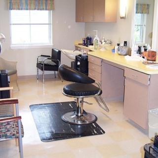 A well-organized salon interior featuring a barber chair and hair styling products.