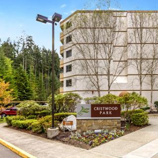Entrance to Greenwood Park, featuring modern architecture amidst a landscaped setting.