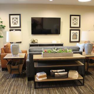 A stylish living room featuring modern furniture, decorative artwork, and a cozy atmosphere.