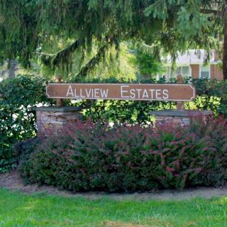 Entrance sign for Allview Estates surrounded by lush greenery.