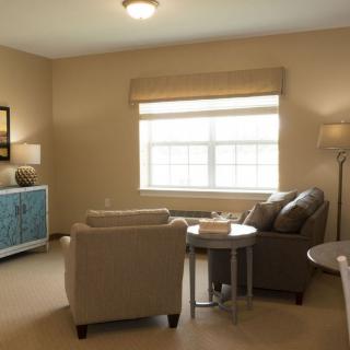 A cozy living room featuring comfortable seating and soft lighting.