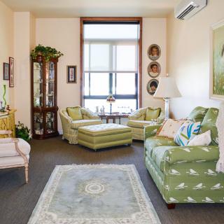 A cozy living room with patterned sofas and elegant decor.
