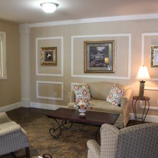 A cozy living room featuring elegant furnishings and decorative artwork.