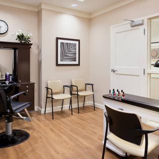 A well-organized salon interior featuring a hair cutting station and waiting area.