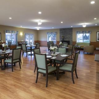 A spacious and well-lit dining area featuring modern furniture and a cozy atmosphere.