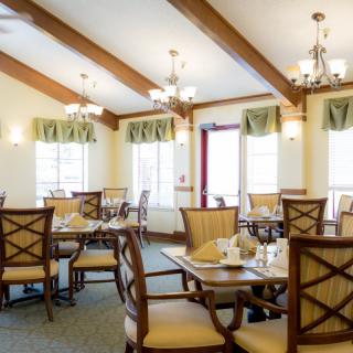 A cozy dining room with elegant table settings and ample natural light.