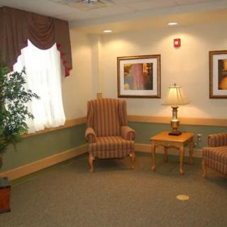 A cozy waiting room with comfortable seating and decorative elements.