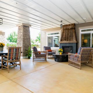 A cozy outdoor patio with comfortable seating and a fireplace.