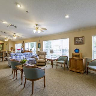 A spacious and well-lit lounge area with comfortable seating and large windows.