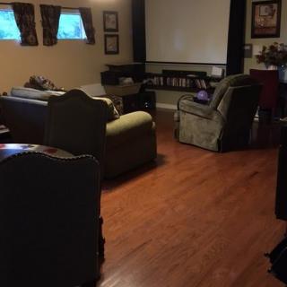 A cozy home theater setup with comfortable seating and a large projector screen.