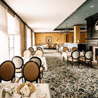 An elegantly designed dining room featuring plush seating and a warm color palette.