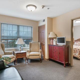 A cozy living room featuring comfortable seating, a television, and natural light from the window.