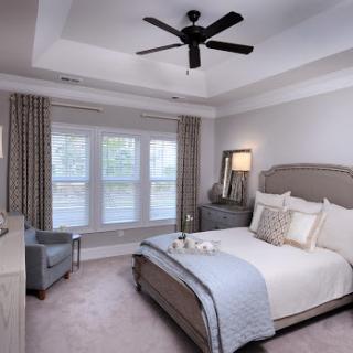 A serene and stylish modern bedroom featuring soft neutral tones and elegant furnishings.