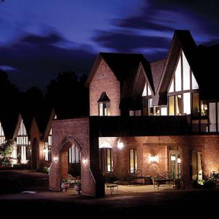 A beautifully lit residential building showcasing modern architectural design at night.