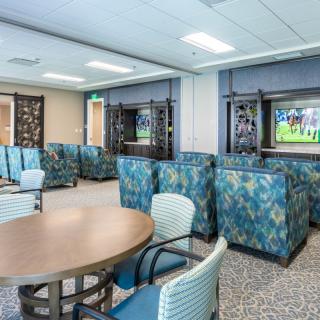 A modern lounge area with comfortable seating and a television.